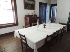 This is the dining room with its large table that could accommodate the many people who lived in the home and who visited the home.